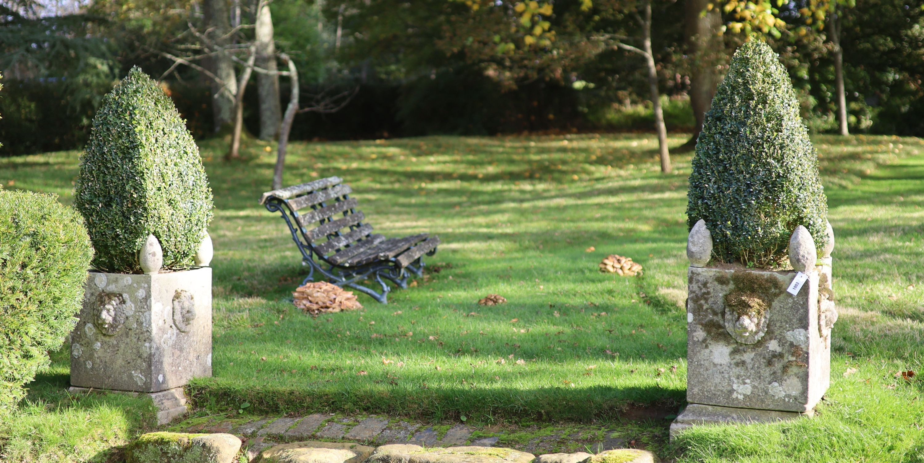 A pair of reconstituted stone garden planters, with lions mask decoration, height 74cm width 48cm